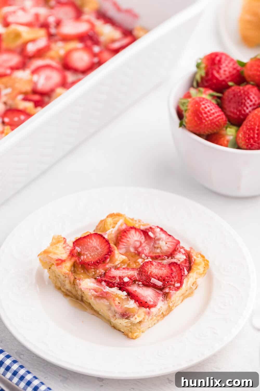 Strawberry & Coconut Breakfast Casserole - A simple and elegant make-ahead breakfast casserole with tender croissants, sweet strawberries, and a tropical coconut flavor.