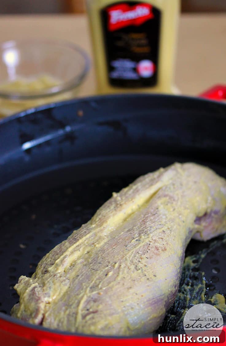 Brown Sugar Dijon Glazed Pork Tenderloin 5 A simple yet memorable Brown Sugar Dijon Pork Tenderloin, presented with a dipping sauce, ready for a family dinner.