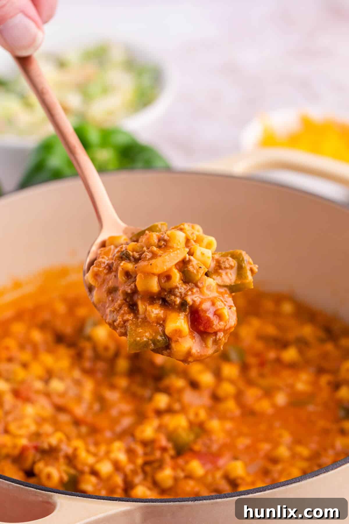 Skillet Stuffed Pepper Pasta 3 A serving spoon with unstuffed pepper pasta, showcasing the rich sauce and tender ingredients.