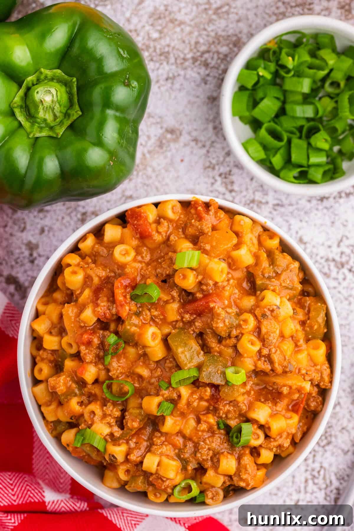 Skillet Stuffed Pepper Pasta 4 A bowl of unstuffed pepper pasta, garnished with fresh herbs.