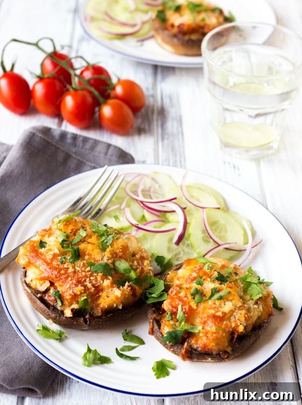 Creamy Butterbean and Cheese Stuffed Mushrooms 3 A beautifully presented plate of cheese and butterbean stuffed mushrooms, accompanied by a fresh red onion salad.