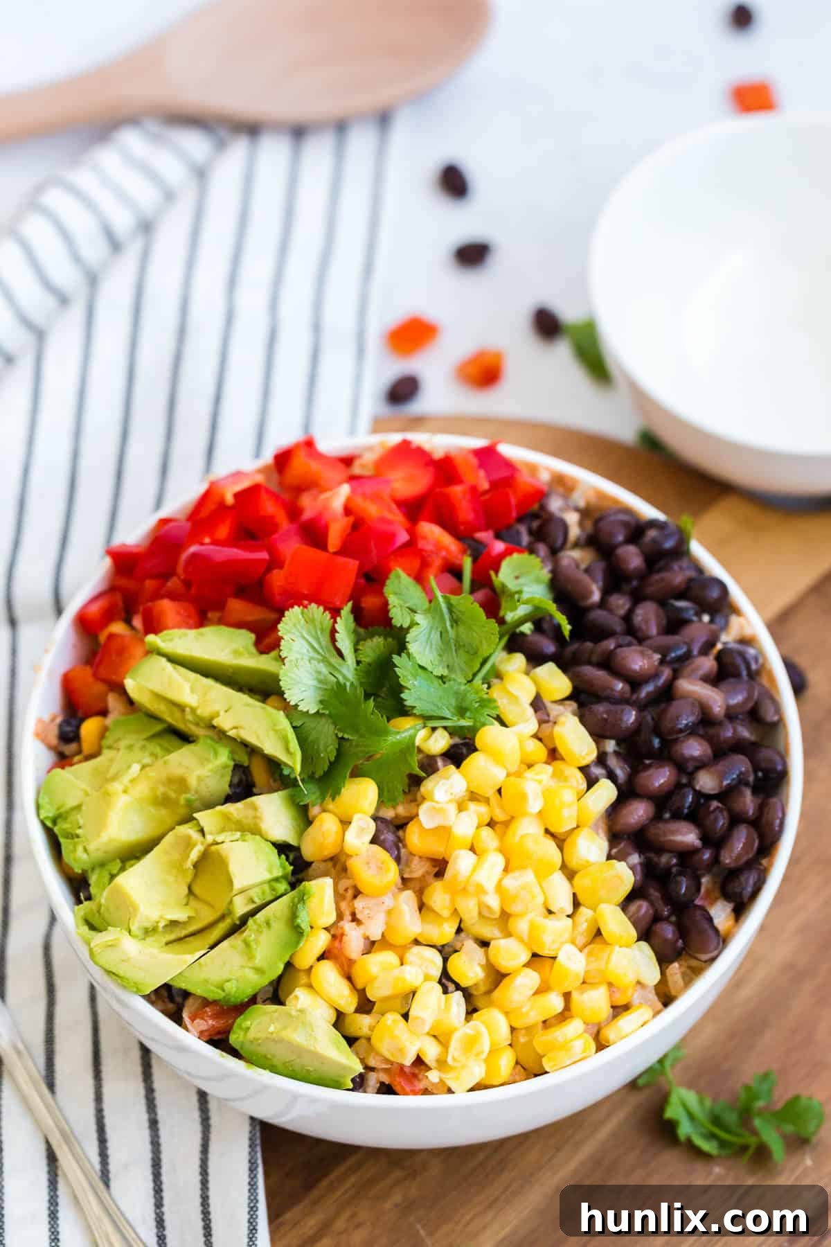 Cauliflower rice enchilada bowl with a generous amount of toppings in the bowl.