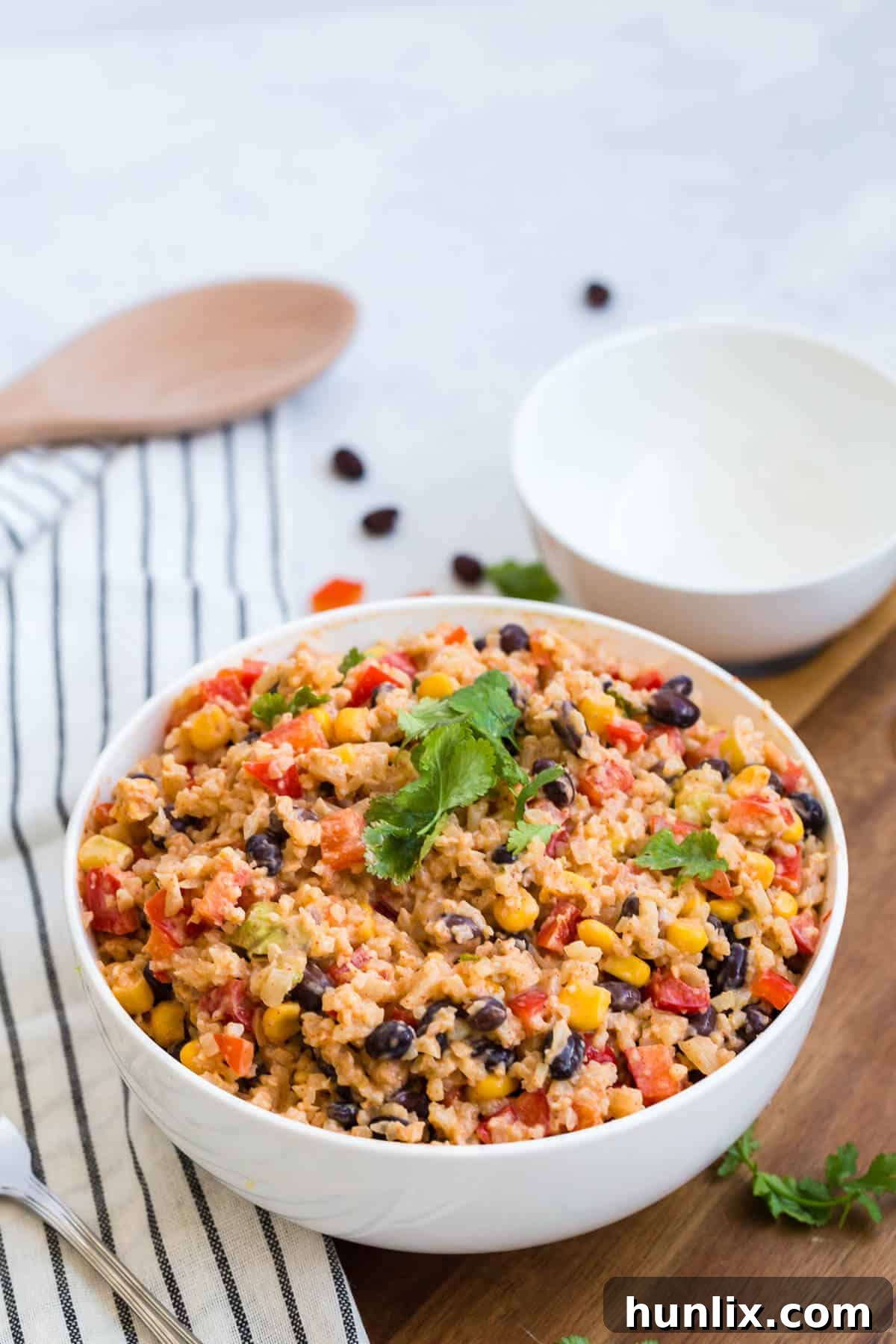 Cauliflower rice enchilada bowl topped with fresh cilantro for garnish.