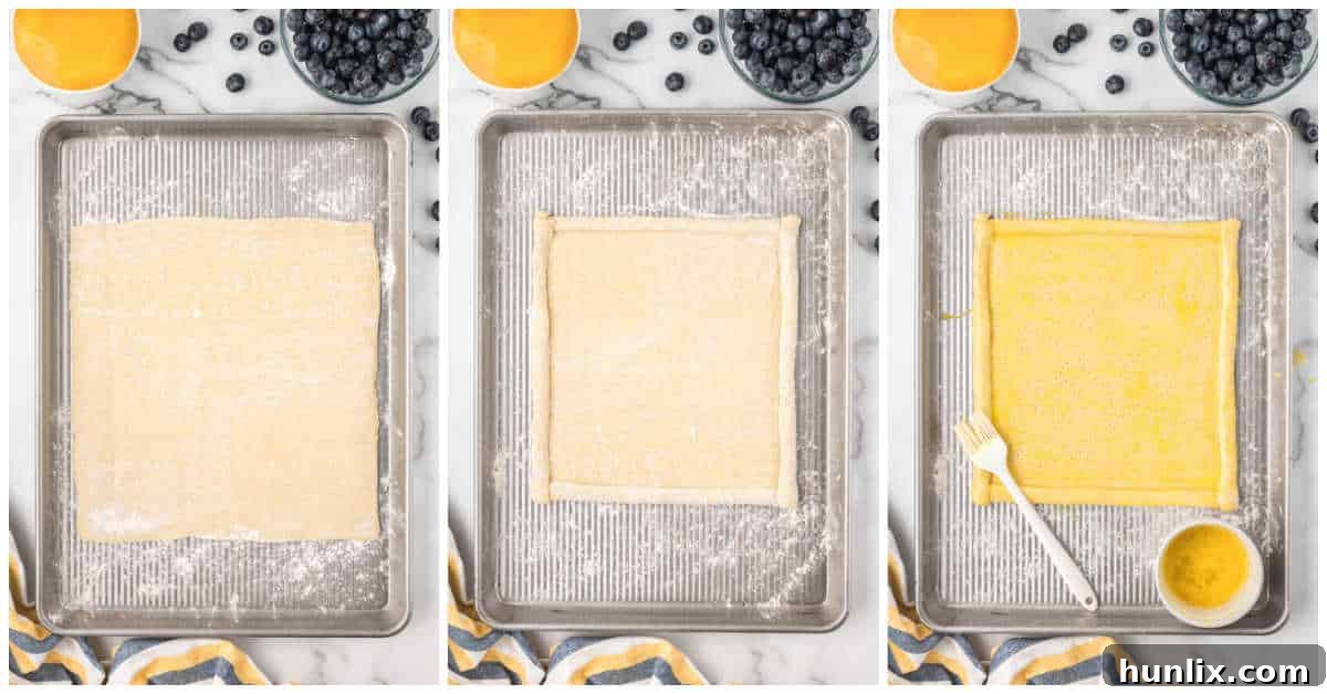 Puff pastry sheet being prepared for baking, showing poked holes and egg wash.