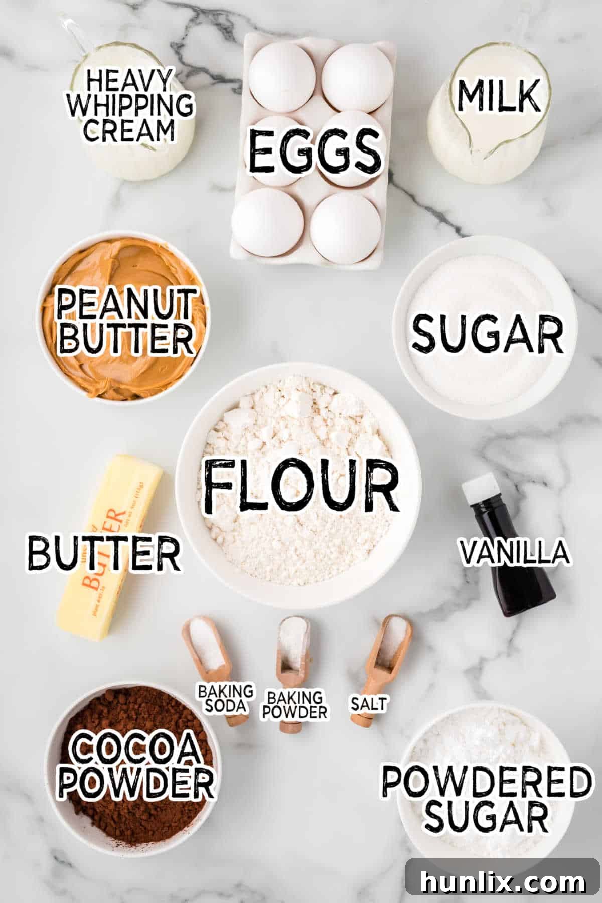 All the dry and wet ingredients for chocolate peanut butter cupcakes laid out on a white marble counter, ready for baking.