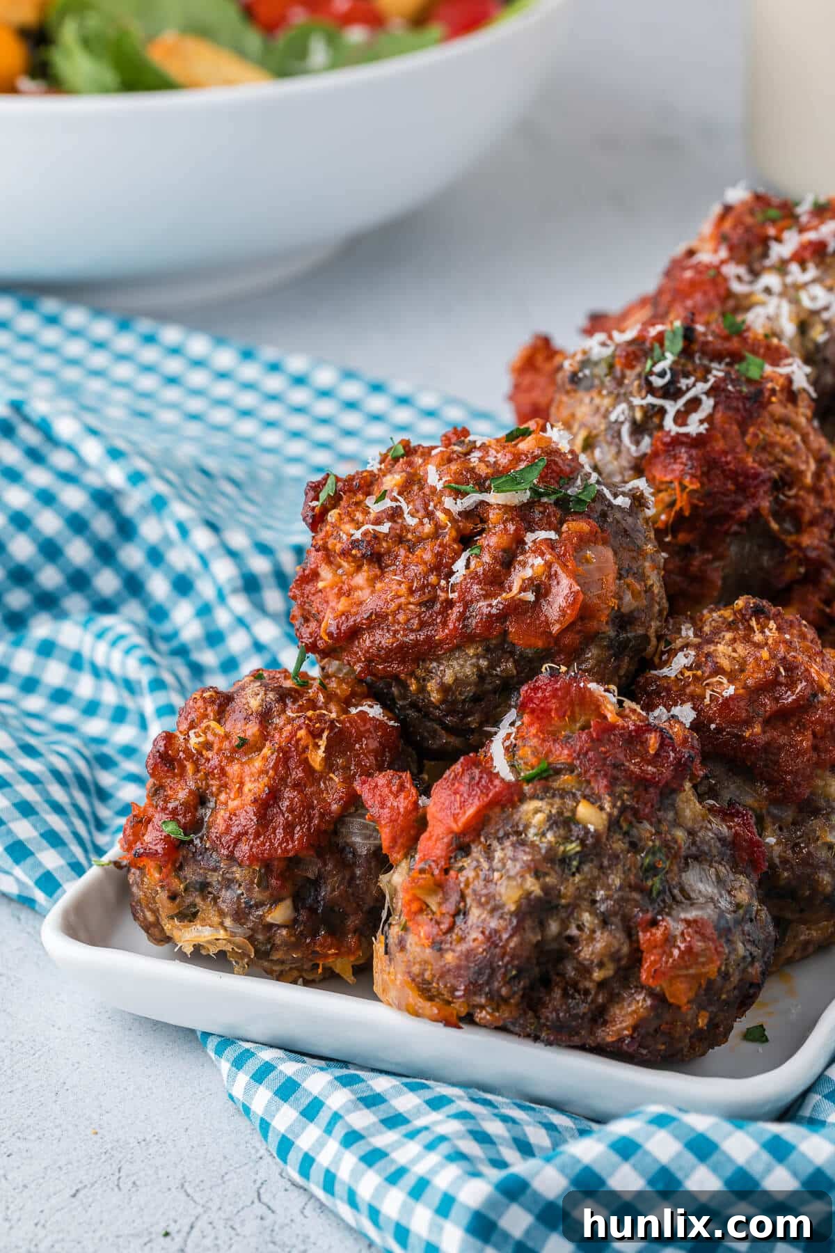 A vibrant platter of freshly baked cheesy meatballs, ready to be enjoyed.