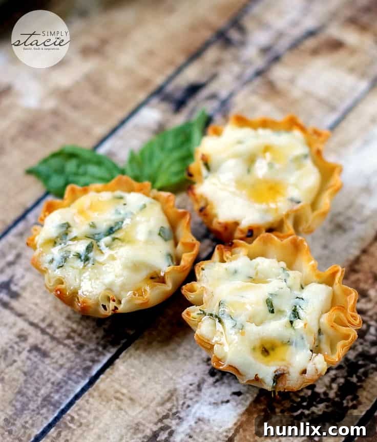 Springtime Herb Tartlets with Honey-Kissed Goat Cheese 5 A hand holding a Spring Herb Tartlet, emphasizing its dainty size and perfect for party snacking.