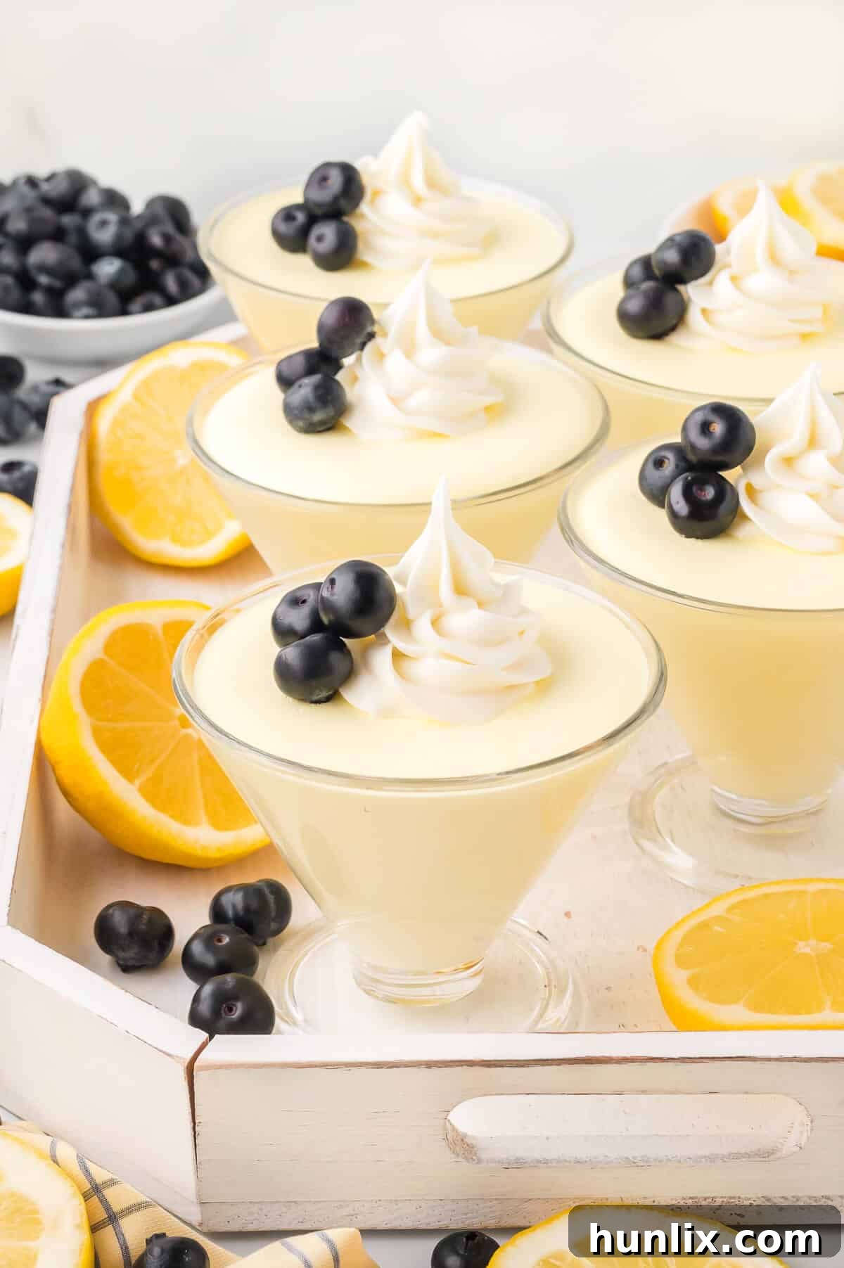 A group of lemon cheesecake mousse servings arranged beautifully on a tray.