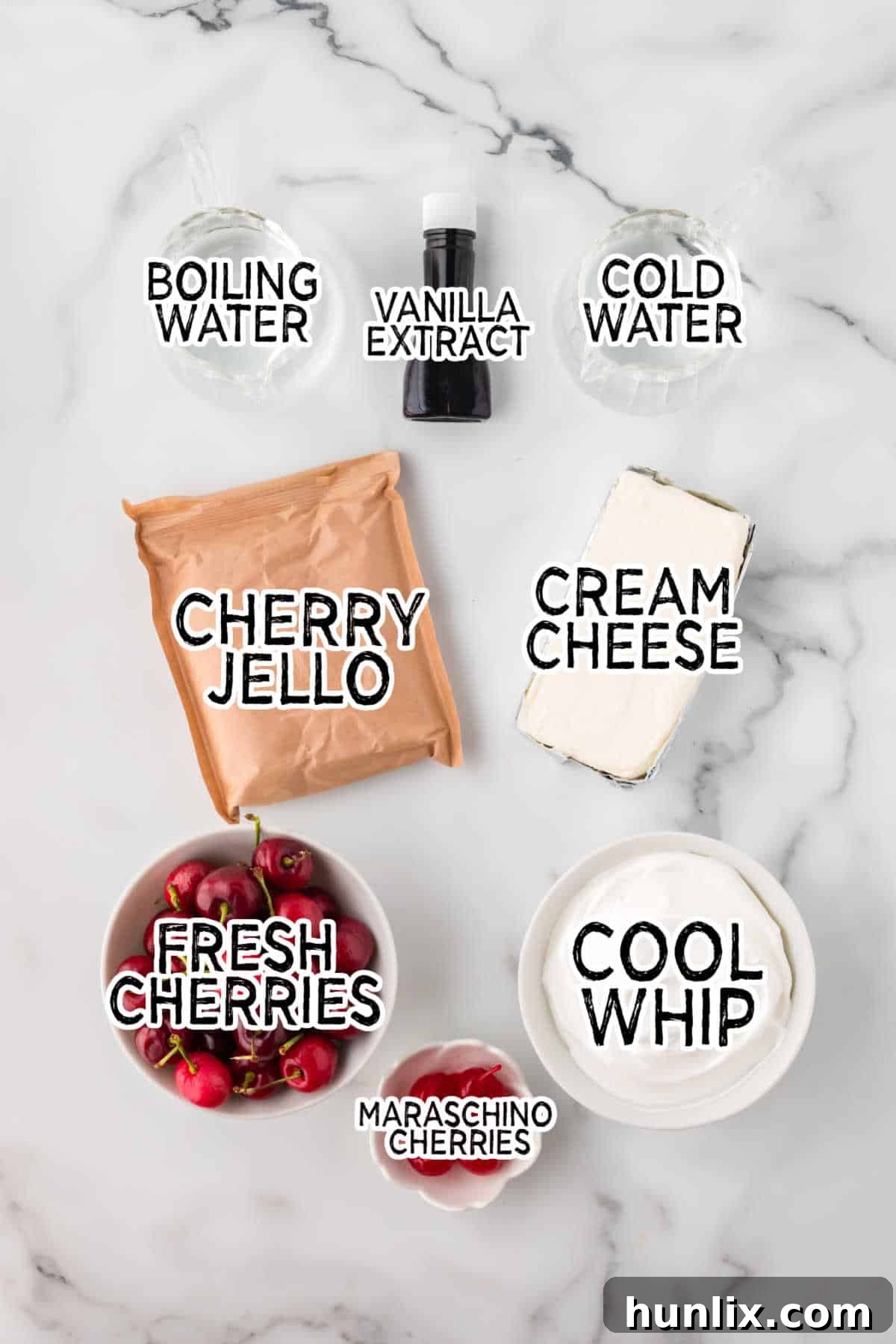 Velvet Cherry Dream 3 Ingredients for making cherry mousse laid out on a white surface, including cherry jello, fresh cherries, cream cheese, cool whip, and vanilla extract.