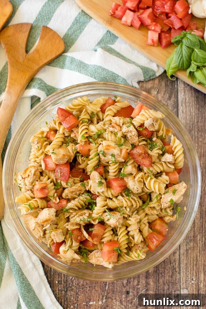 Fresh Bruschetta Chicken Pasta Salad with vibrant tomatoes and basil, perfect for summer meals.