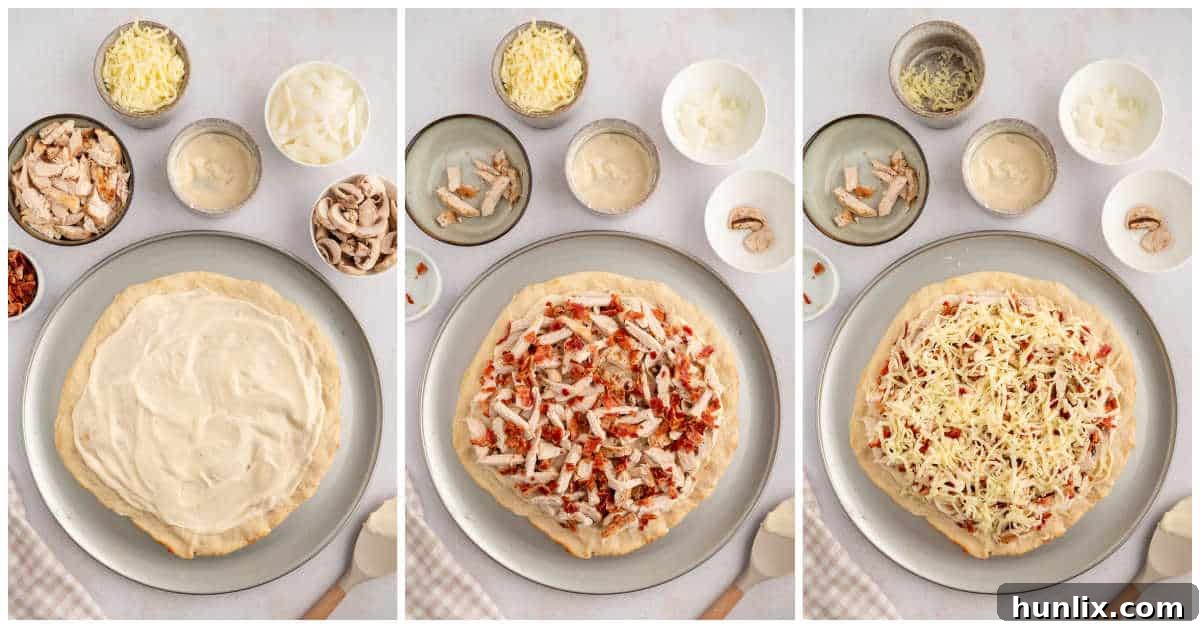 A top-down view of a partially assembled chicken bacon alfredo pizza, with the creamy sauce spread on the crust and various toppings like chicken, bacon, mushrooms, and onions evenly distributed, before the final layer of cheese.