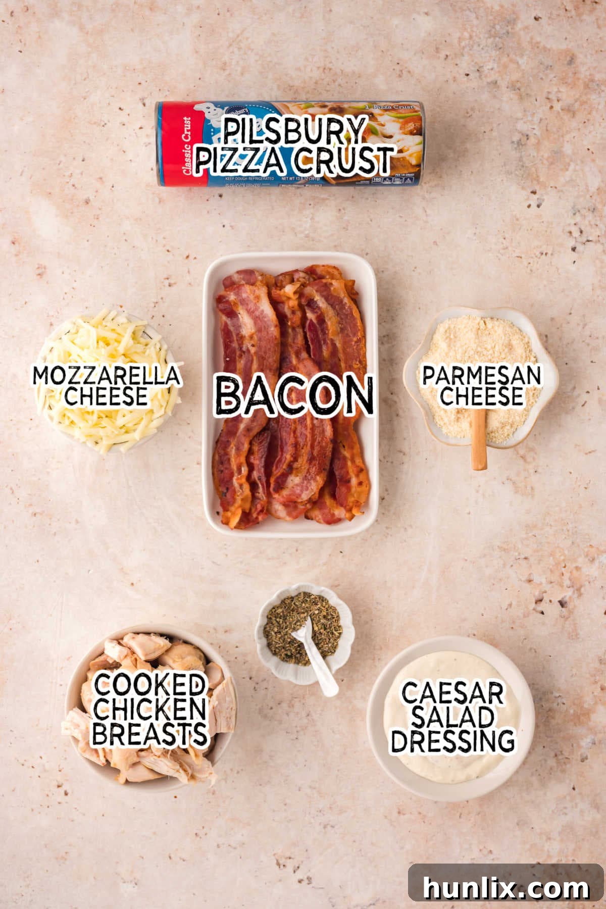 Signature Chicken Caesar Pizza 3 All the fresh ingredients neatly arranged on a beige surface, ready for making Chicken Caesar Pizza.