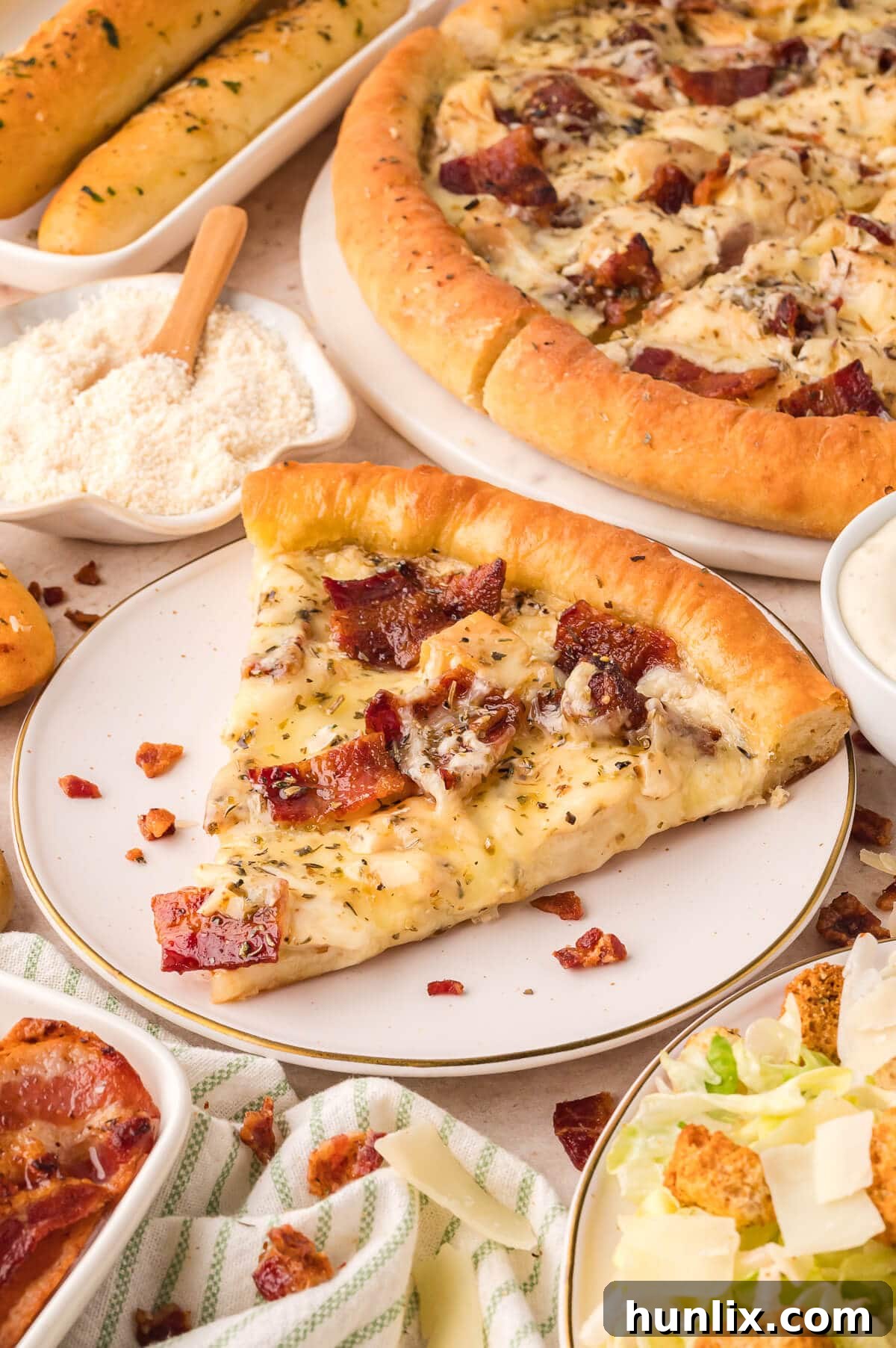 Signature Chicken Caesar Pizza 6 A vibrant slice of Chicken Caesar Pizza on a white plate, ready to be enjoyed.