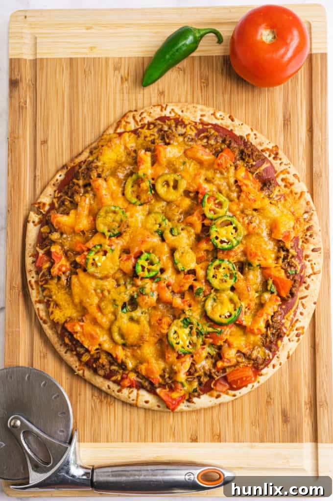 Taco Pizza - Bring Mexican night to your pizzas! Loaded with ground beef, cheese, and tons of veggies, you won't even miss the tortillas.