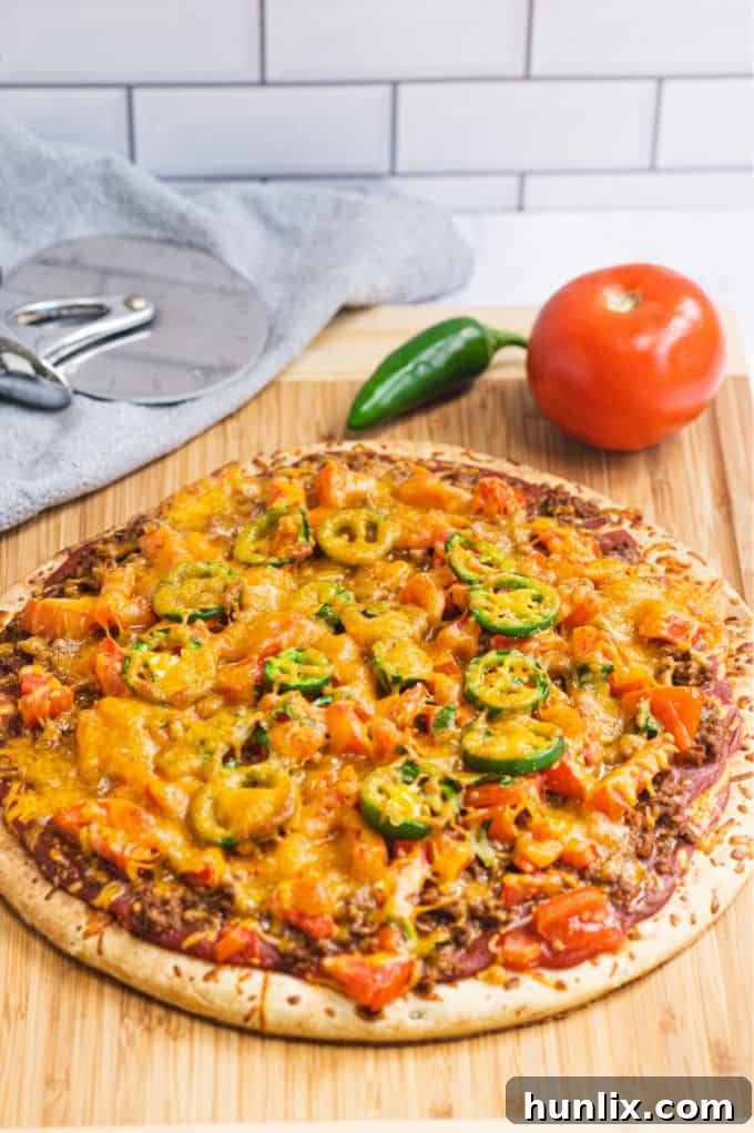 Taco Pizza - Bring Mexican night to your pizzas! Loaded with ground beef, cheese, and tons of veggies, you won't even miss the tortillas.