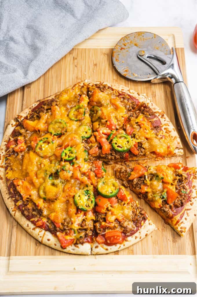 Taco Pizza - Bring Mexican night to your pizzas! Loaded with ground beef, cheese, and tons of veggies, you won't even miss the tortillas.