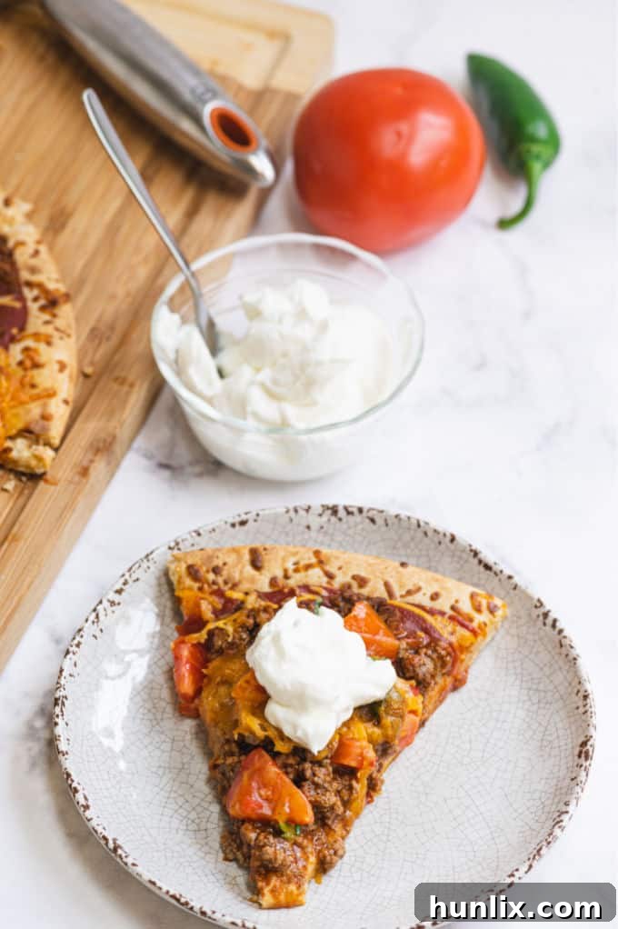 Taco Pizza - Bring Mexican night to your pizzas! Loaded with ground beef, cheese, and tons of veggies, you won't even miss the tortillas.
