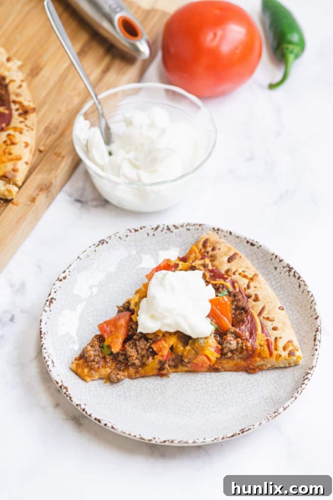 Taco Pizza - Bring Mexican night to your pizzas! Loaded with ground beef, cheese, and tons of veggies, you won't even miss the tortillas.