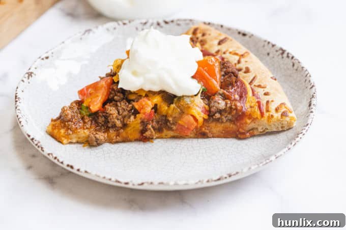 Taco Pizza - Bring Mexican night to your pizzas! Loaded with ground beef, cheese, and tons of veggies, you won't even miss the tortillas.