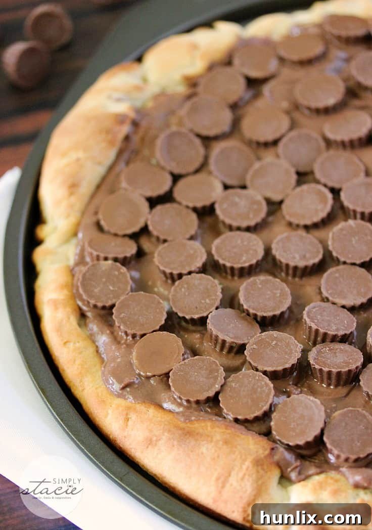 Reese Peanut Butter Pizza - Reese's lovers, rejoice! This dessert pizza is covered with a chocolatey peanut butter spread and topped with mini Reese's cups for a double dose of the sweet treat.