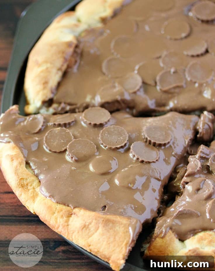 Reese Peanut Butter Pizza - Reese's lovers, rejoice! This dessert pizza is covered with a chocolatey peanut butter spread and topped with mini Reese's cups for a double dose of the sweet treat.