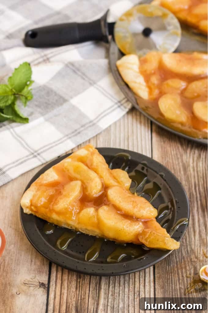 Caramel Apple Pizza - The PERFECT fall dessert pizza! Sweet cinnamon apple pie filling with rich caramel covering a basic pizza crust for the taste of pie without the mess and wait.