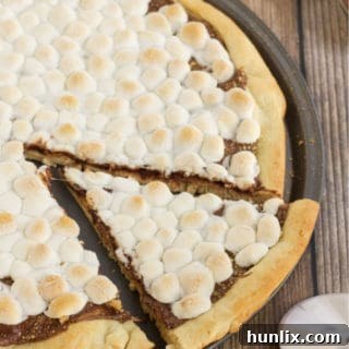 Gooey Smores Dessert Pizza 9 S'mores Pizza - S'mores indoors! Bring the camping to the oven with this graham cracker, chocolate, and marshmallow pizza for a great family night treat.