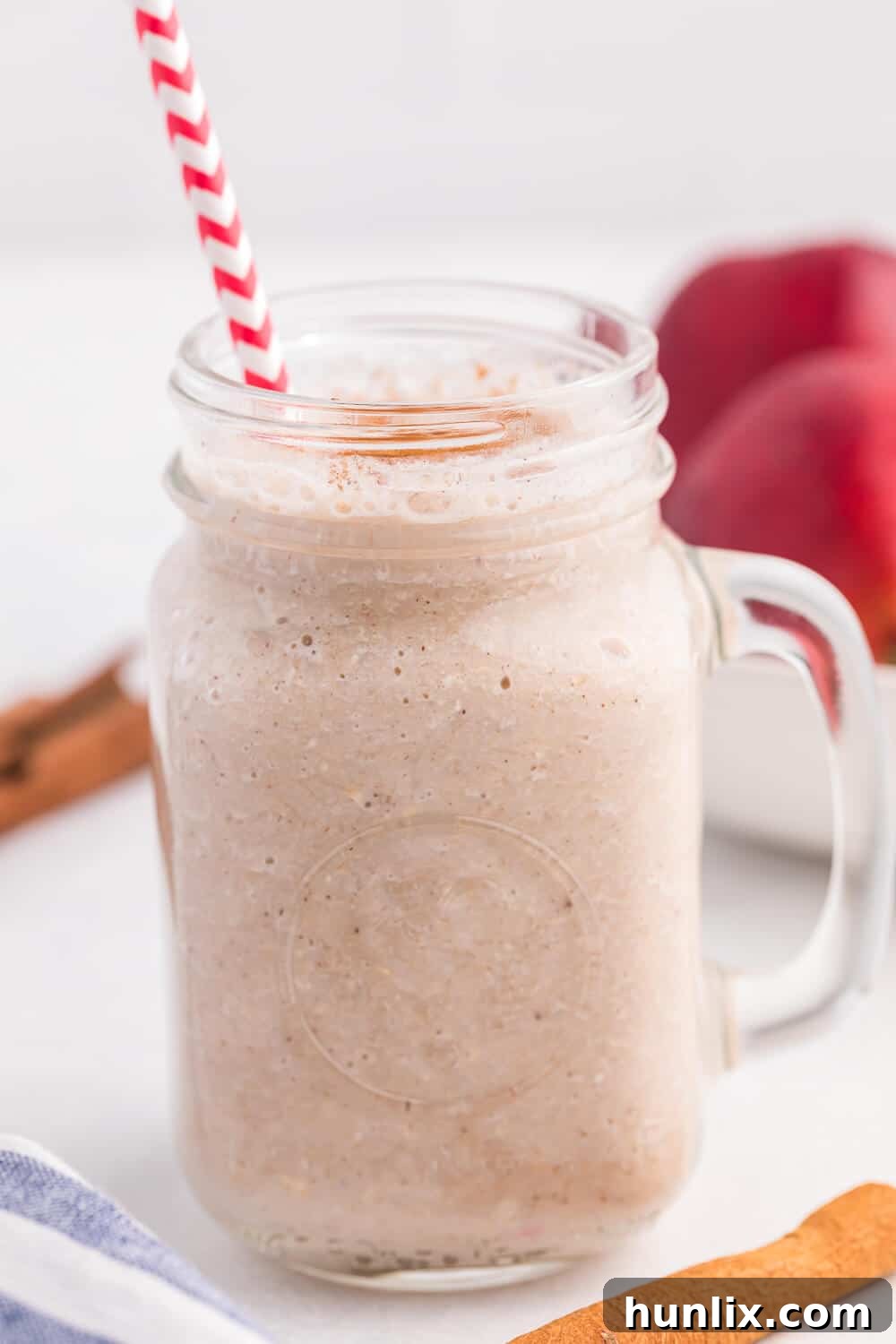 Autumn Spiced Apple Blend 5 The finished Apple Spice Smoothie in a clear glass on a white background.