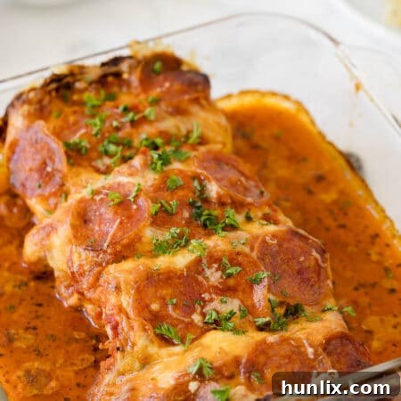 Pizza stuffed chicken in a casserole pan.
