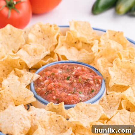 Garden salsa on a serving platter with tortilla chips.