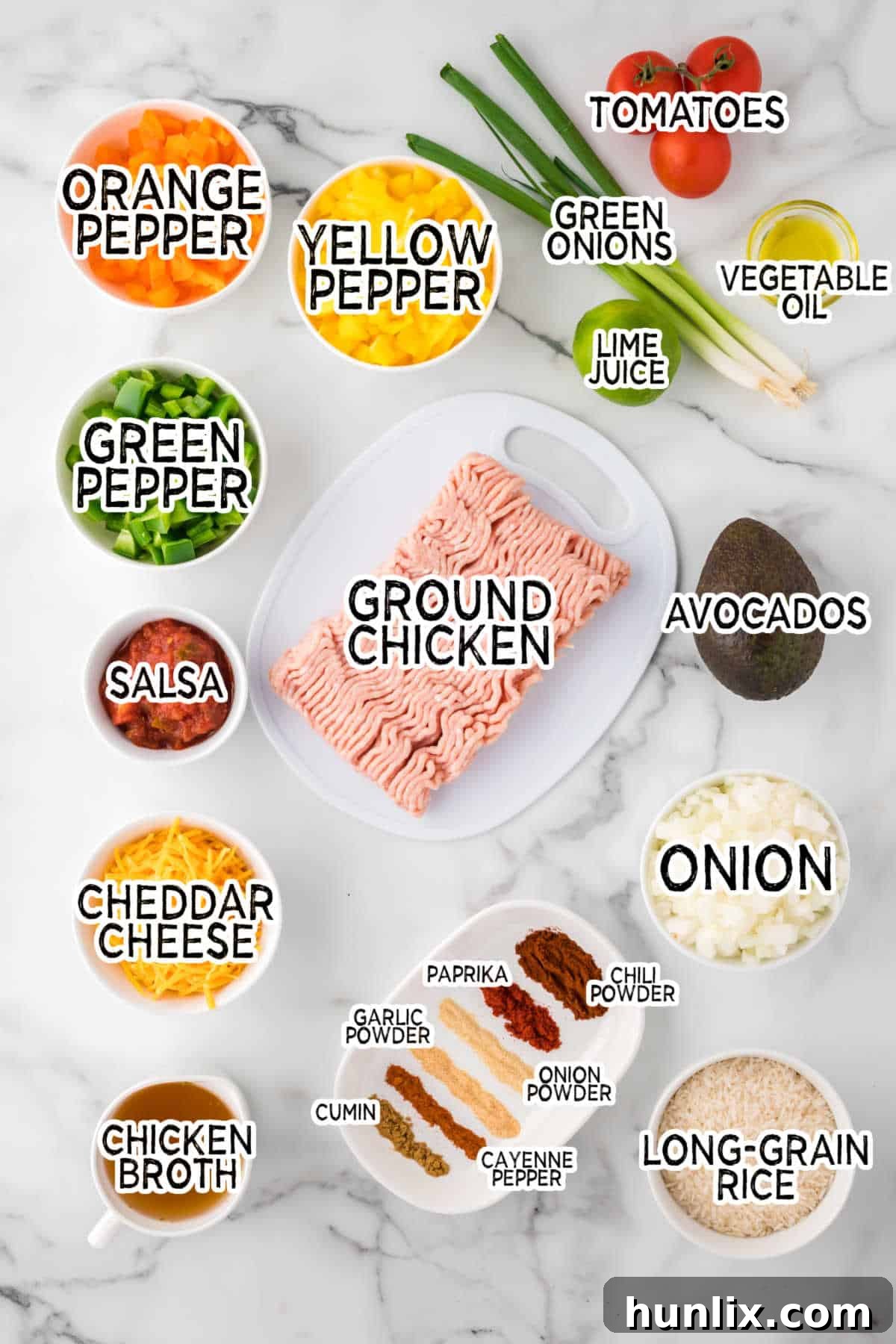 Assortment of fresh ingredients laid out for one-pot chicken fajita rice: bell peppers, onions, ground chicken, rice, spices, salsa.