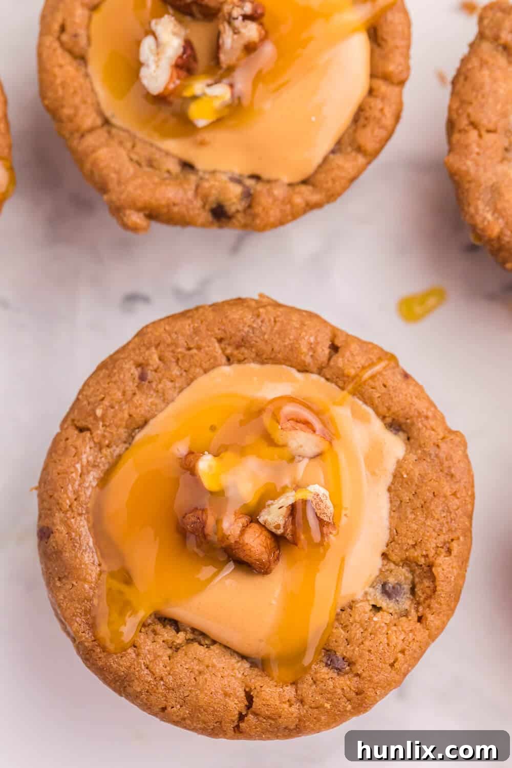 Caramel Stuffed Cookie Cups 3 close up of a single caramel cookie cup with a smooth, glossy caramel filling