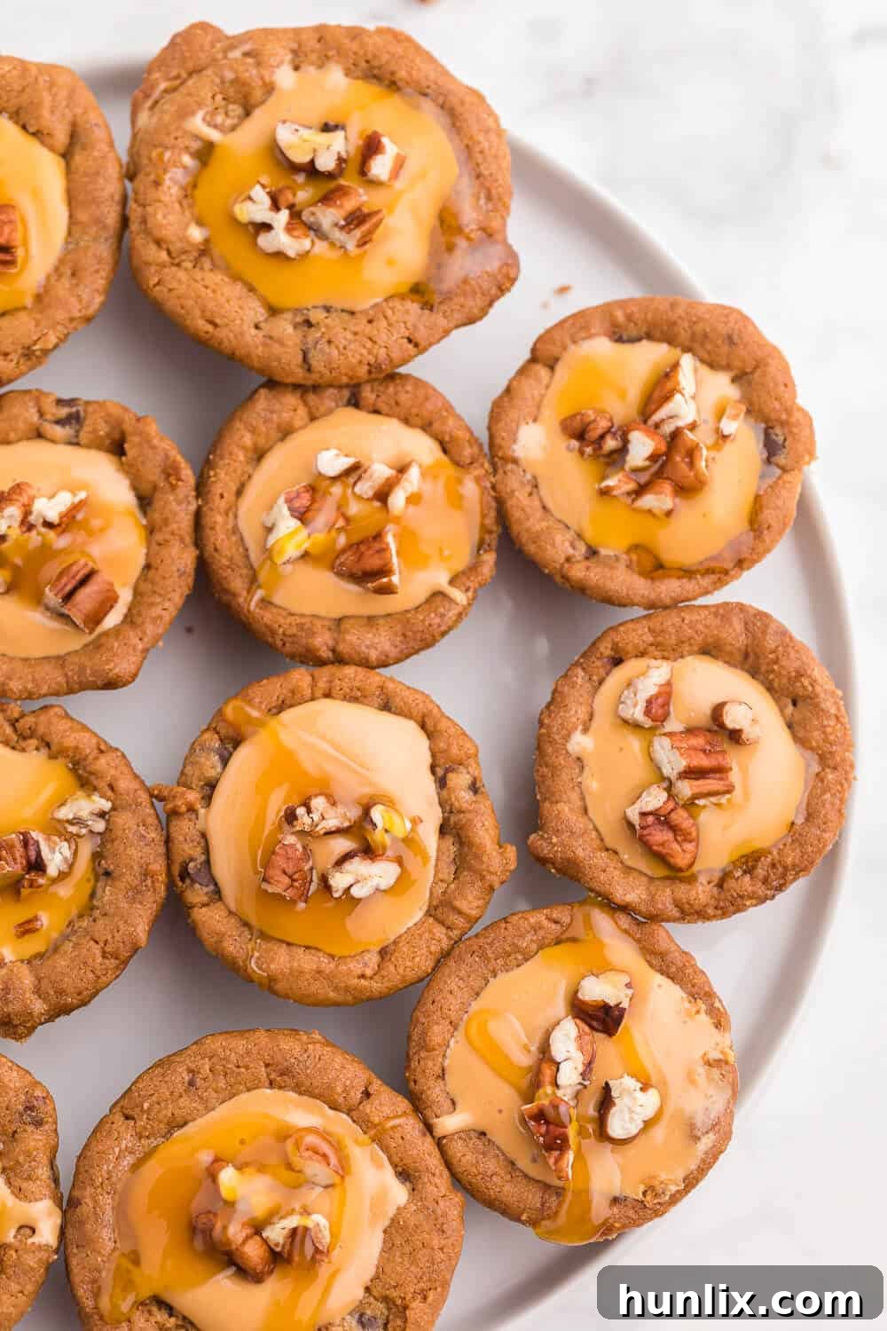 Caramel Stuffed Cookie Cups 4 caramel cookie cups arranged neatly on a white plate, ready for serving