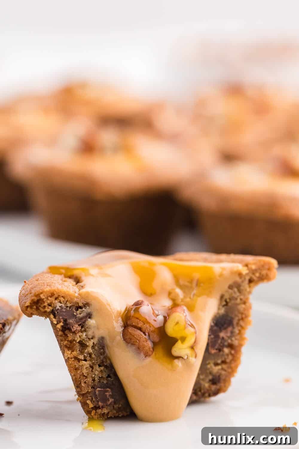 Caramel Stuffed Cookie Cups 6 A caramel cookie cup cut in half, revealing the soft cookie texture and smooth caramel filling inside