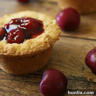 A single Cherry Cake Cup with a golden cake base and glossy cherry filling, ready to eat.