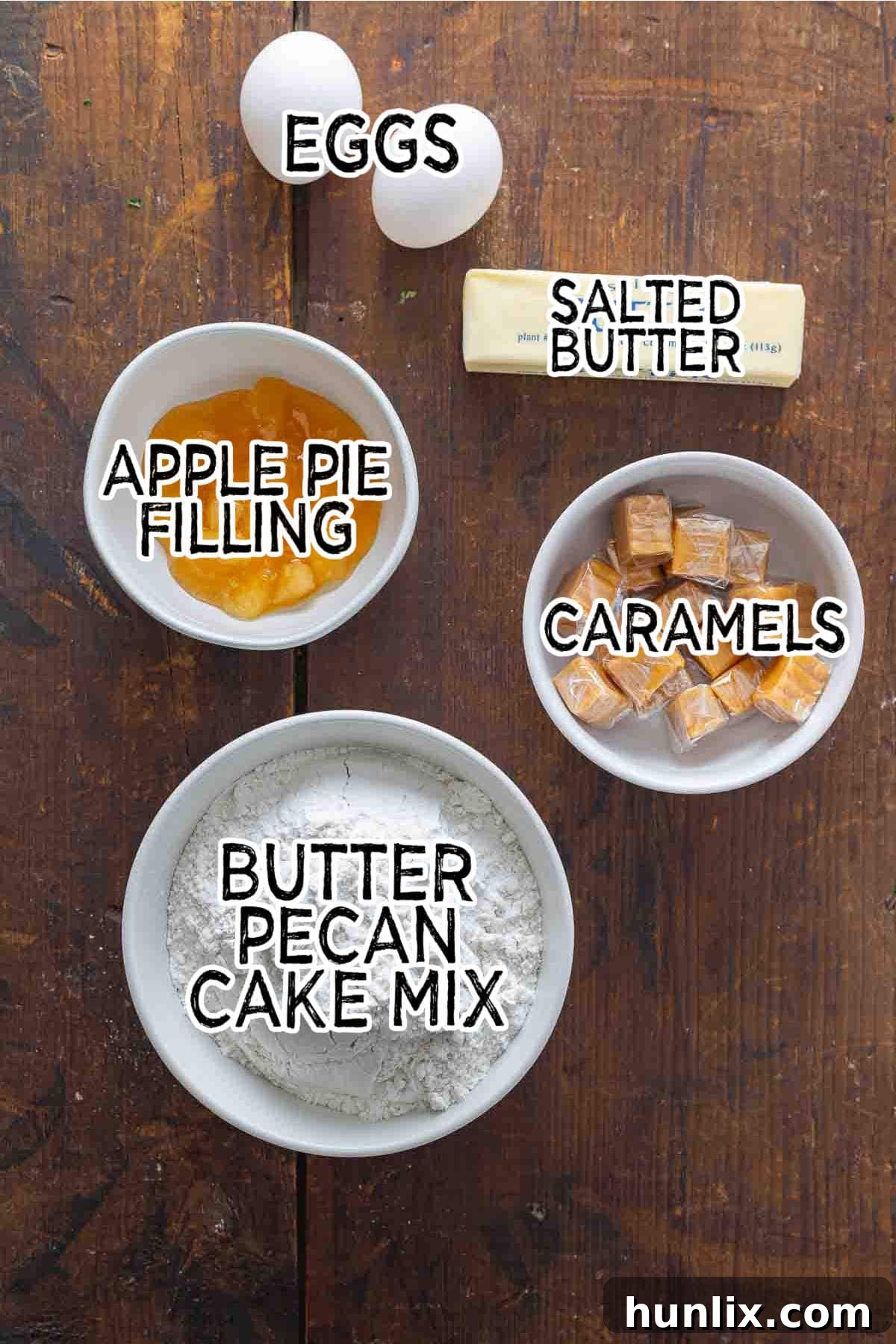 Ingredients for Caramel Apple Cake Cups laid out on a rustic wooden surface.