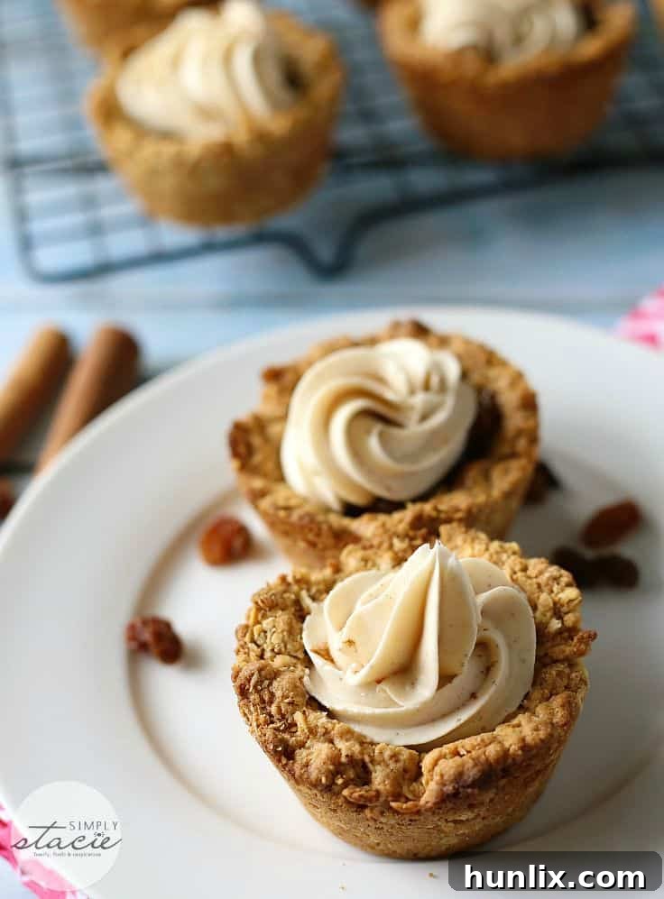 Delightful Oatmeal Raisin Cookie Cups topped with smooth cream cheese frosting, perfect for parties and gatherings.