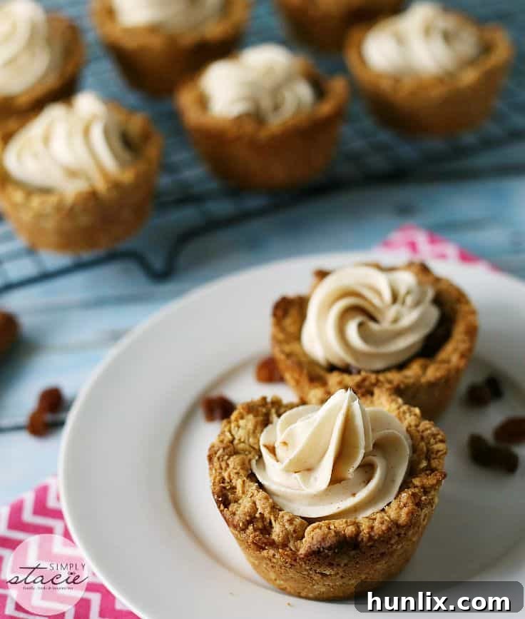 A close-up of Oatmeal Raisin Cookie Cups with cream cheese frosting and a hint of the raisin filling.