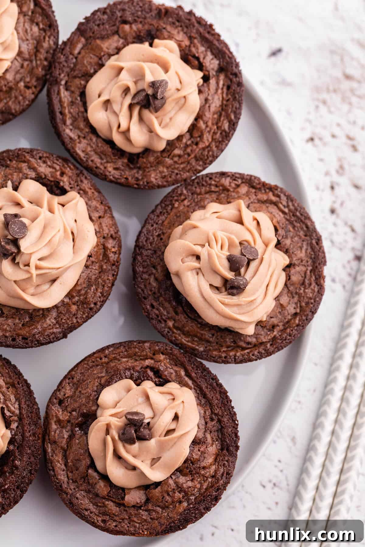 Decadent Brownie Cheesecake Bites 5 Close-up of Brownie Cheesecake Cups, showing the rich brownie base and creamy filling with chocolate chips.
