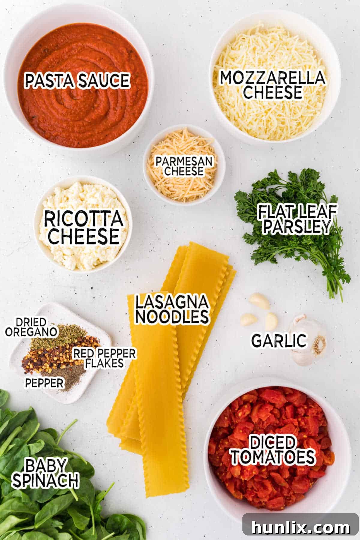 Ingredients for making a delicious slow cooker lasagna, including cheese, pasta, and vegetables.