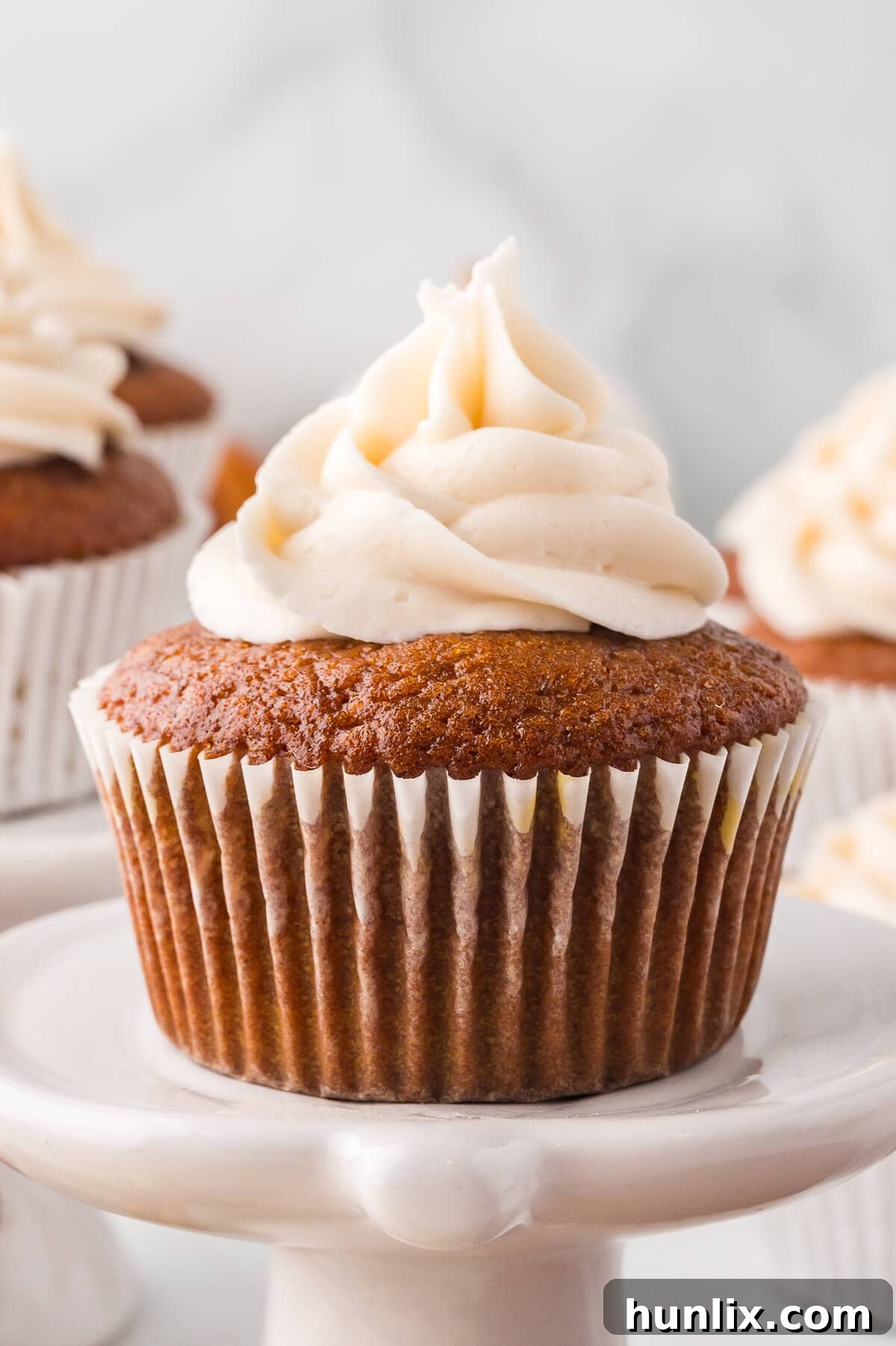 A cupcake on a white stand.