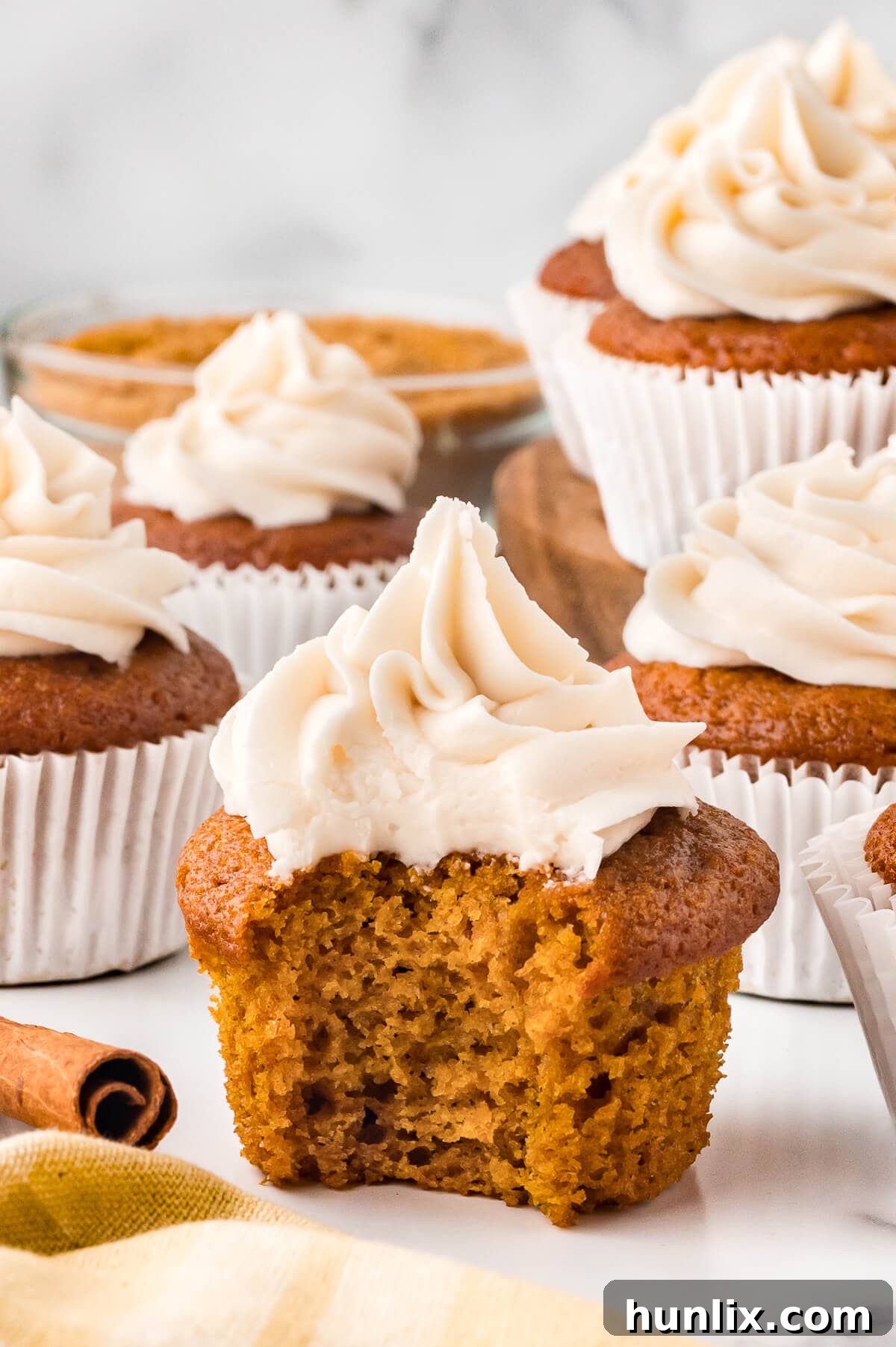 A cupcake with a bite out of it.