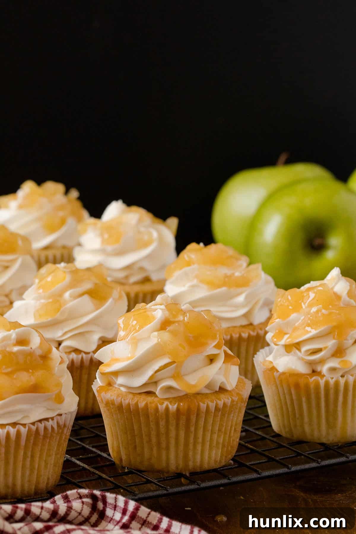 Decadent Caramel Apple Cupcakes 3 Close-up of frosted Caramel Apple Cupcakes, showcasing the golden caramel drizzle and fluffy frosting.