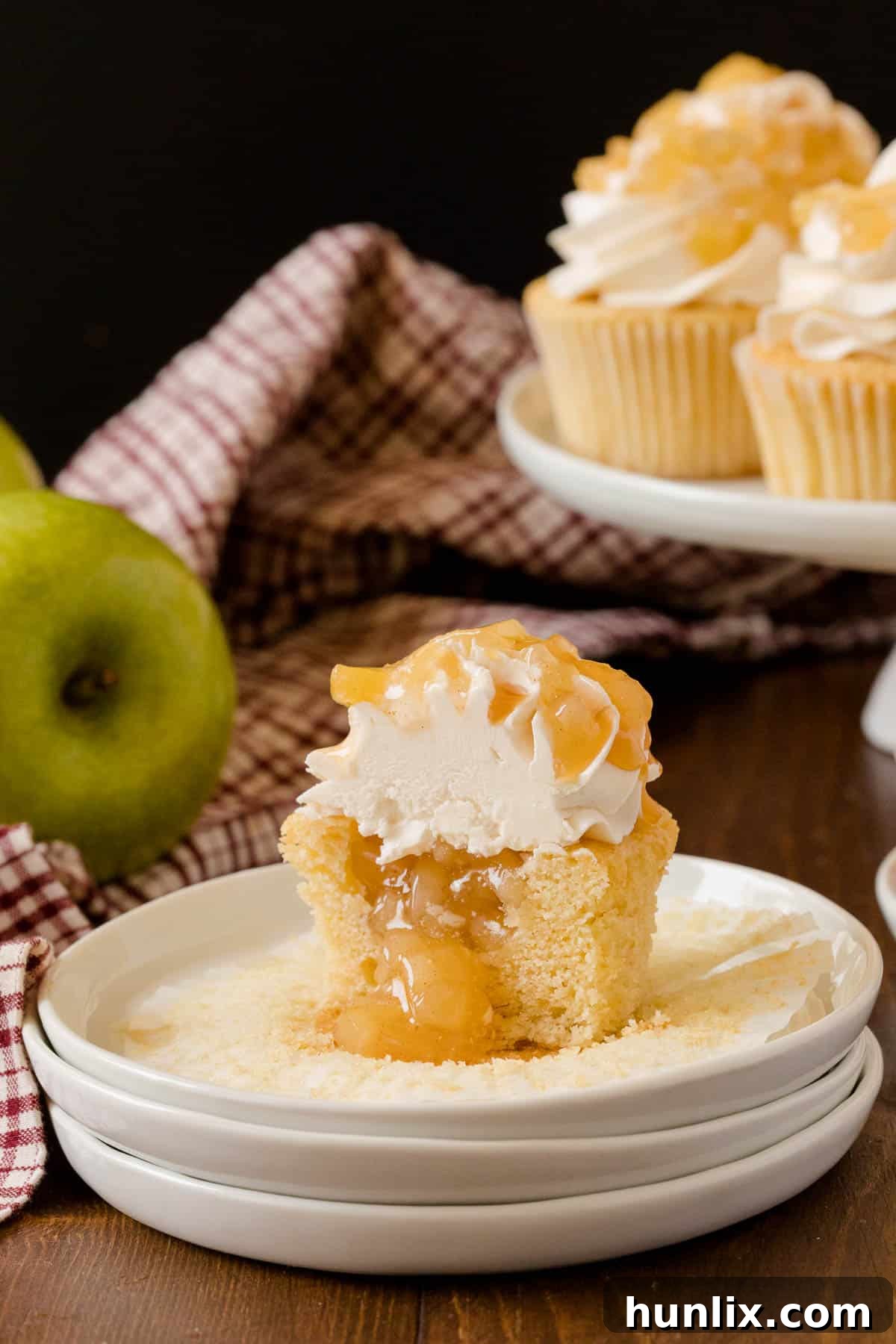 Decadent Caramel Apple Cupcakes 5 Single Caramel Apple Cupcake on a white plate, showcasing its rich frosting and delightful presentation.