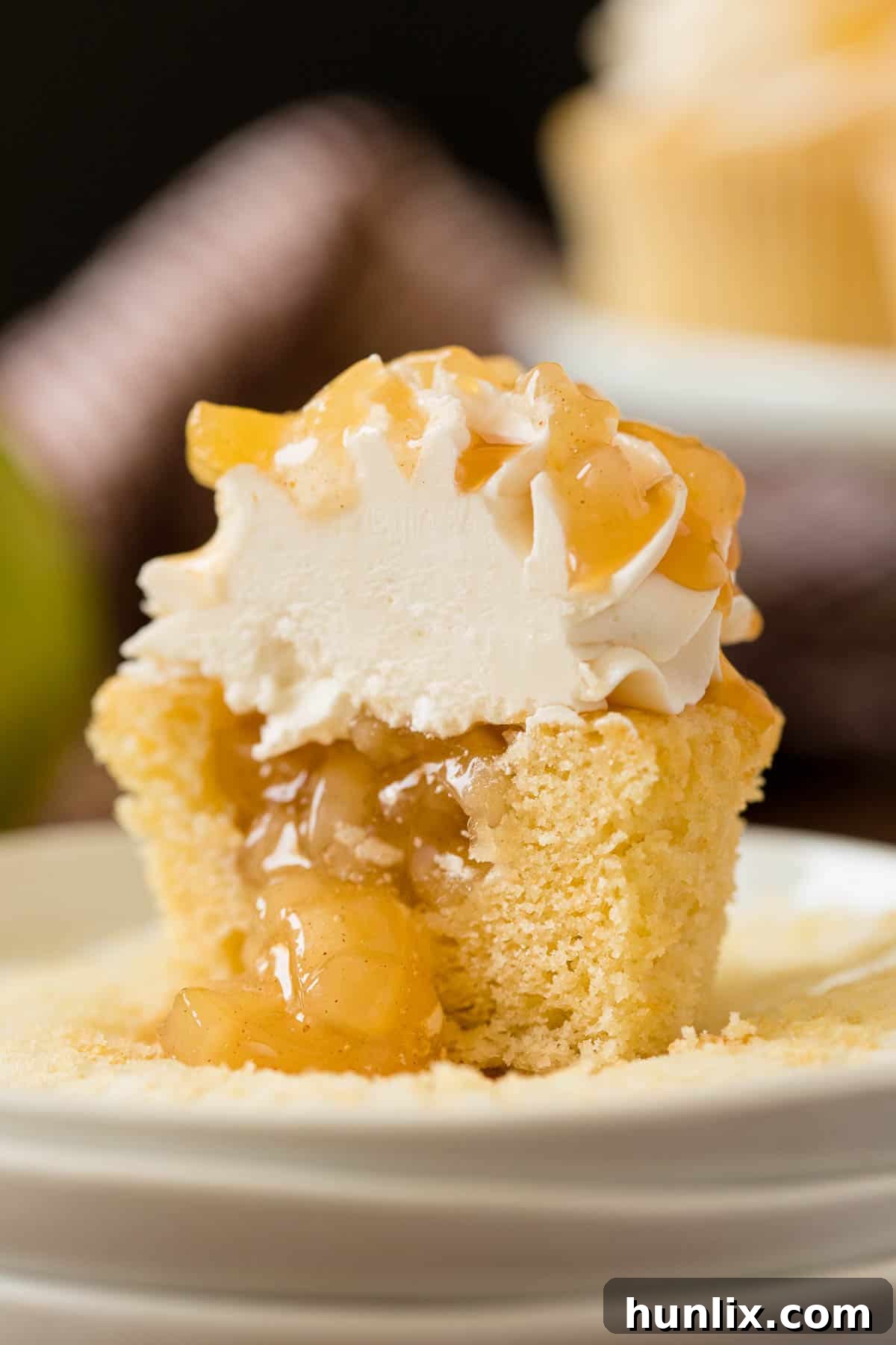 Decadent Caramel Apple Cupcakes 6 An array of freshly baked Caramel Apple Cupcakes displayed on a cooling rack, glistening with caramel.