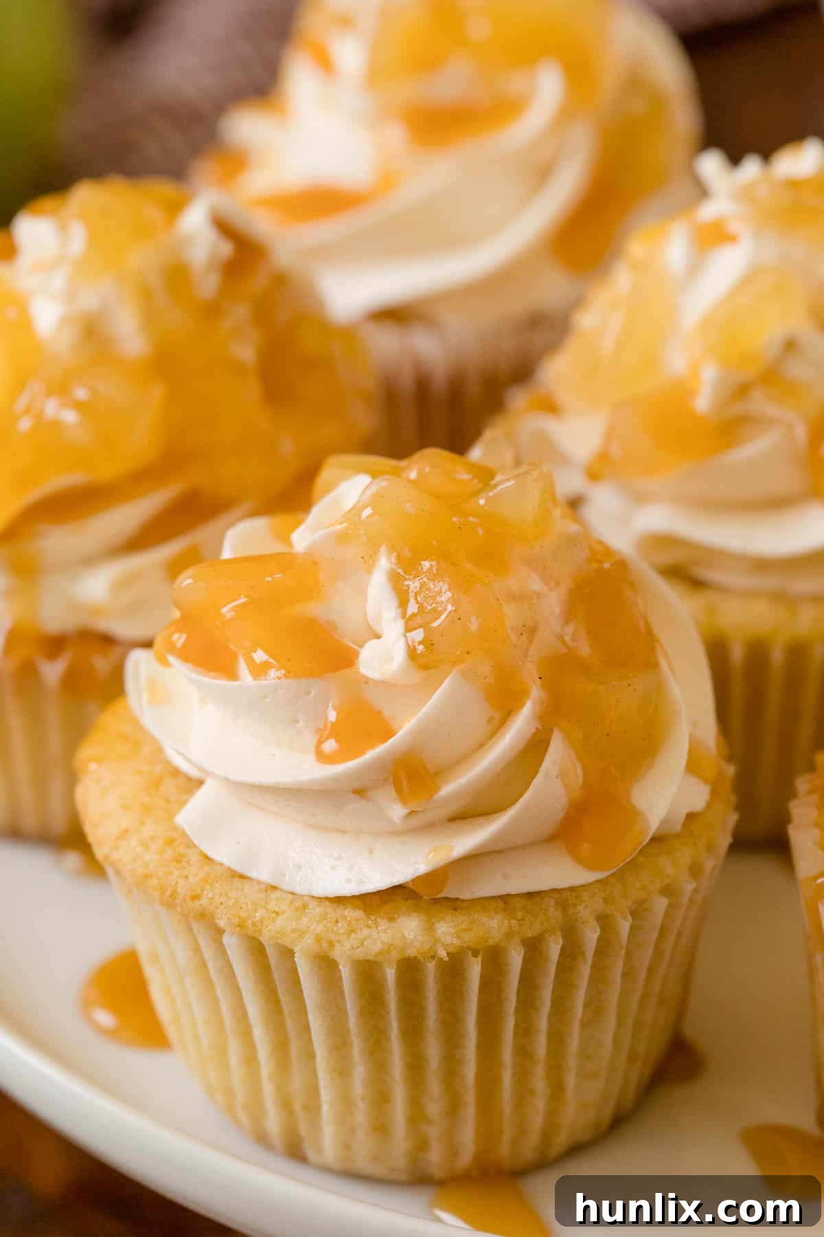 Decadent Caramel Apple Cupcakes 7 Close-up overhead shot of a Caramel Apple Cupcake, highlighting the textures of the frosting and apple filling.