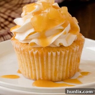 Caramel Apple Cupcakes - Fall in a cupcake! Sweet caramel and apple pie are packed into this delicious handheld dessert.
