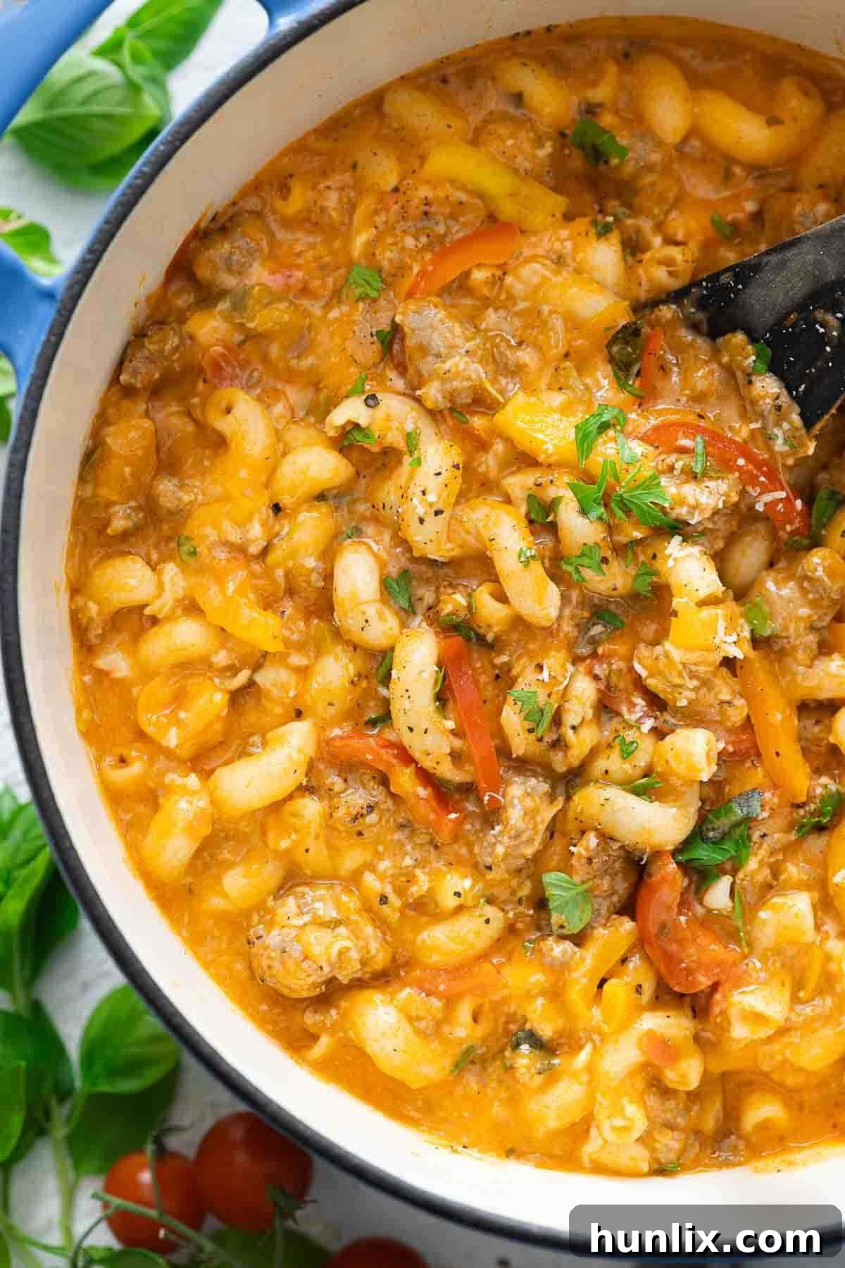 Spicy Sausage Skillet Pasta with Peppers 5 The finished spicy sausage and pepper one-pot pasta simmering in a large Dutch oven.