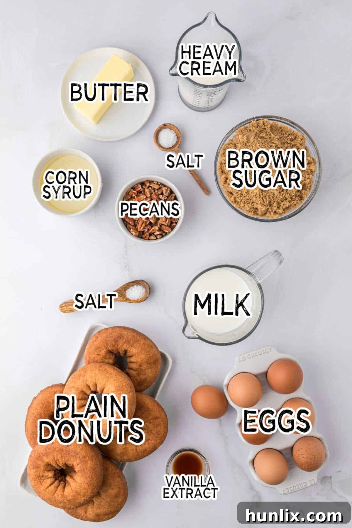 A collection of fresh ingredients laid out on a clean white background, ready for making the casserole.