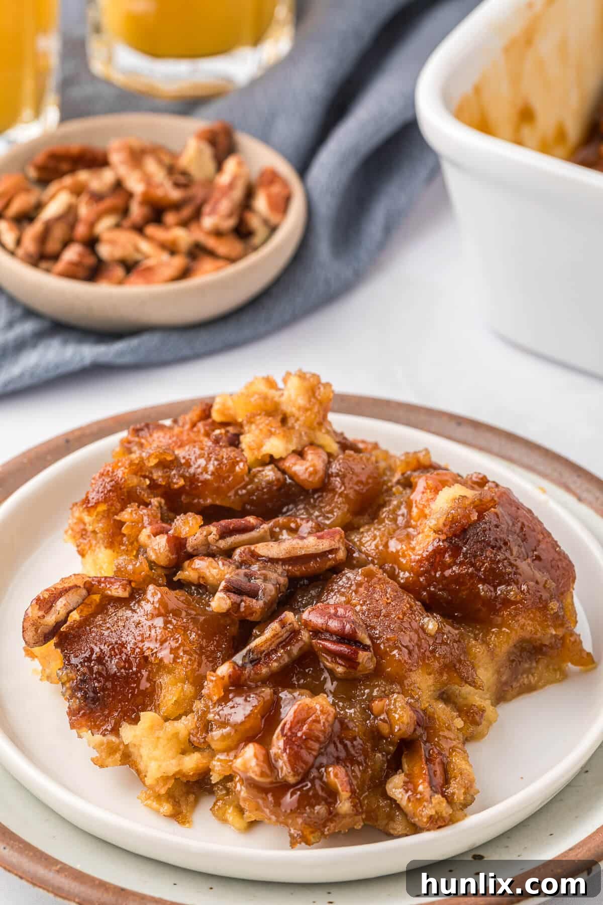 A delightful piece of Caramel Pecan Breakfast Casserole presented on a white plate, ready to be enjoyed.